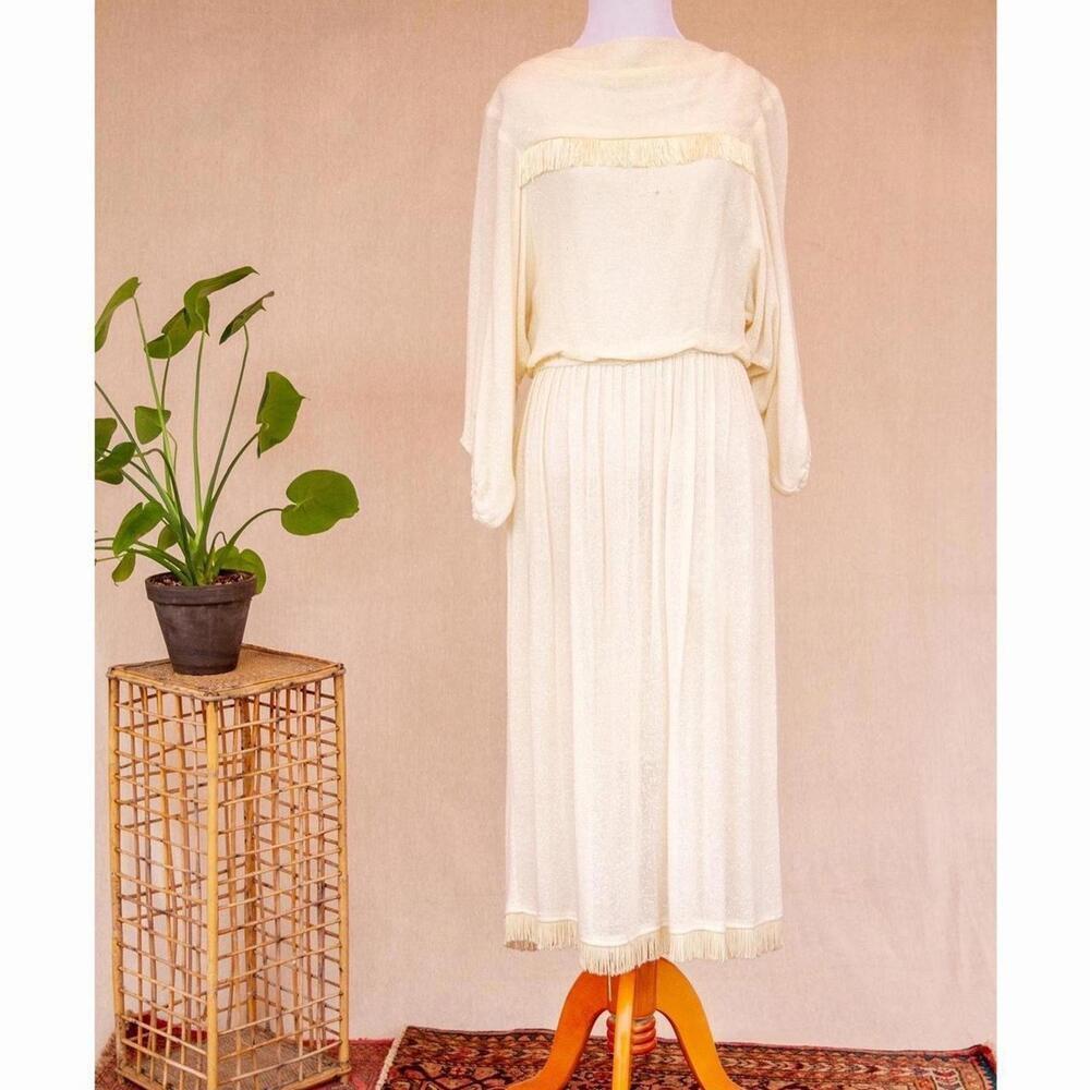 Vintage cream maxi dress with pleated skirt, ballon sleeves, and fringe details